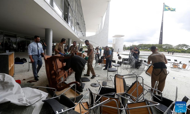 Workers clear damaged furniture outside Planalto Palace, the presidential headquarters, in Brasilia, Brazil, Jan. 9, 2023. Brazil's three branches of government issued a joint statement on Monday, expressing unity and calling on society to remain calm in defense of peace and democracy. (Photo: Xinhua)