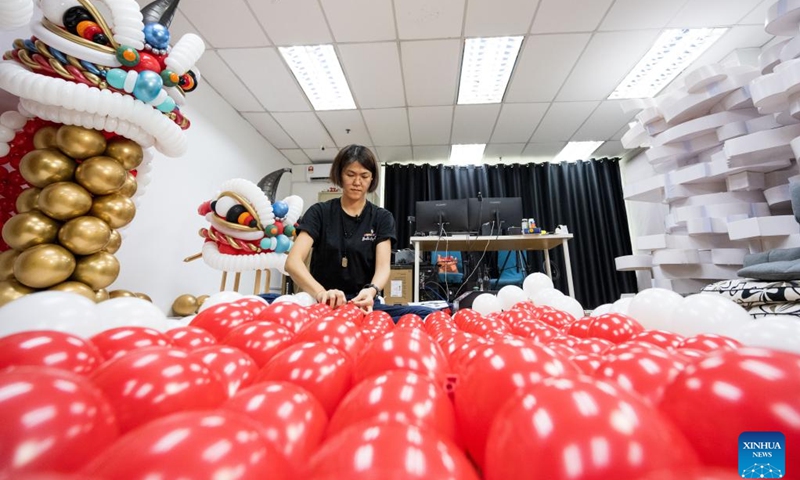 Syndy Tan Sing Yit makes lion dance balloon sculptures in her workshop near Kuala Lumpur, Malaysia, Dec. 31, 2022. Syndy Tan Sing Yit is a Malaysian balloon stylist who has been working on balloon modeling for more than a decade. She has created lion dance balloon sculptures by referring to lion dance graphics and pictures.(Photo: Xinhua)