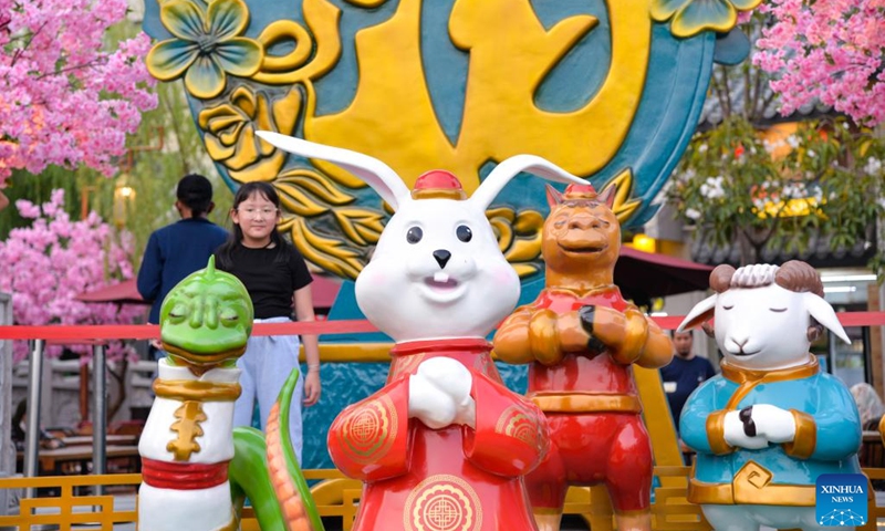 A child poses for photos with sculptures of Chinese Zodiac animals at Chinatown in Jakarta, Indonesia, Jan. 12, 2023. As the Chinese Lunar New Year of the Rabbit approaches, the Chinatown in Jakarta is decorated with a variety of decorations, creating a festive atmosphere for visitors.(Photo: Xinhua)