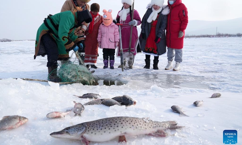 Hezhe people catch fish on the East Lake of Fuyuan City, northeast China's Heilongjiang Province, Jan. 11, 2023. The Hezhes, one of the smallest ethnic minority groups in China, hold various activities to welcome the upcoming Chinese Lunar New Year. (Photo: Xinhua)