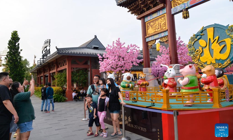 People take photos with sculptures of Chinese Zodiac animals at Chinatown in Jakarta, Indonesia, Jan. 12, 2023. As the Chinese Lunar New Year of the Rabbit approaches, the Chinatown in Jakarta is decorated with a variety of decorations, creating a festive atmosphere for visitors.(Photo: Xinhua)