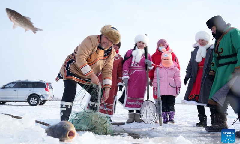 Hezhe people catch fish on the East Lake of Fuyuan City, northeast China's Heilongjiang Province, Jan. 11, 2023. The Hezhes, one of the smallest ethnic minority groups in China, hold various activities to welcome the upcoming Chinese Lunar New Year. (Photo: Xinhua)