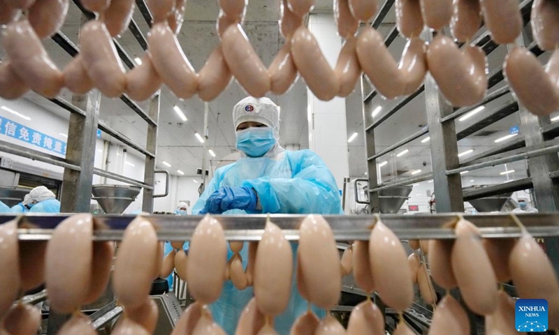 Employees work in a sausage factory in Yutian County, Tangshan City, north China's Hebei Province, Jan. 12, 2023. The food processing enterprises in Yutian ramped up production to meet the market demands for the upcoming Chinese Lunar New Year.(Photo: Xinhua)