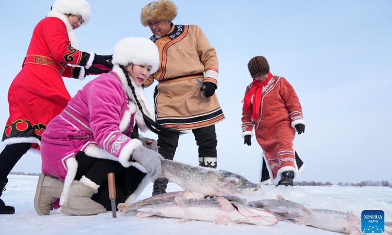 Hezhe people prepare to clean up newly caught fish on the East Lake of Fuyuan City, northeast China's Heilongjiang Province, Jan. 11, 2023. The Hezhes, one of the smallest ethnic minority groups in China, hold various activities to welcome the upcoming Chinese Lunar New Year.(Photo: Xinhua)