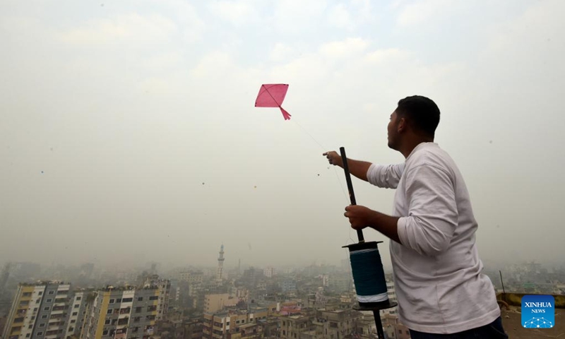 A man flies a kite during Sakrain festival in Dhaka, capital of Bangladesh, Jan. 14, 2023. People in Dhaka celebrate Sakrain festival, also known as Ghuri Utsob or Kite festival, at the end of Poush, the ninth month of the Bengali calendar. Photo: Xinhua