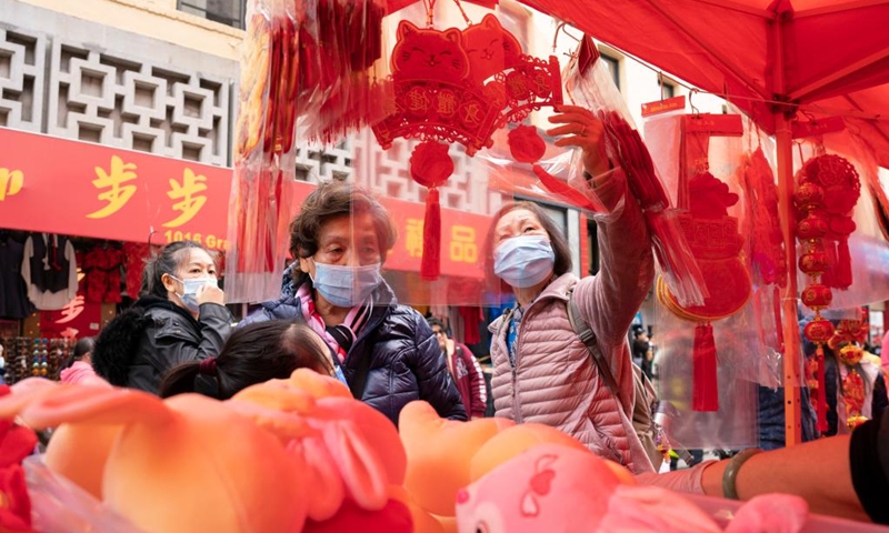 People shop at a fair held for the upcoming Chinese Lunar New Year in Chinatown in San Francisco, California, the United States, Jan. 14, 2023. The two-day fair kicked off here on Saturday, attracting many citizens and tourists. (Photo by Li Jianguo/Xinhua)