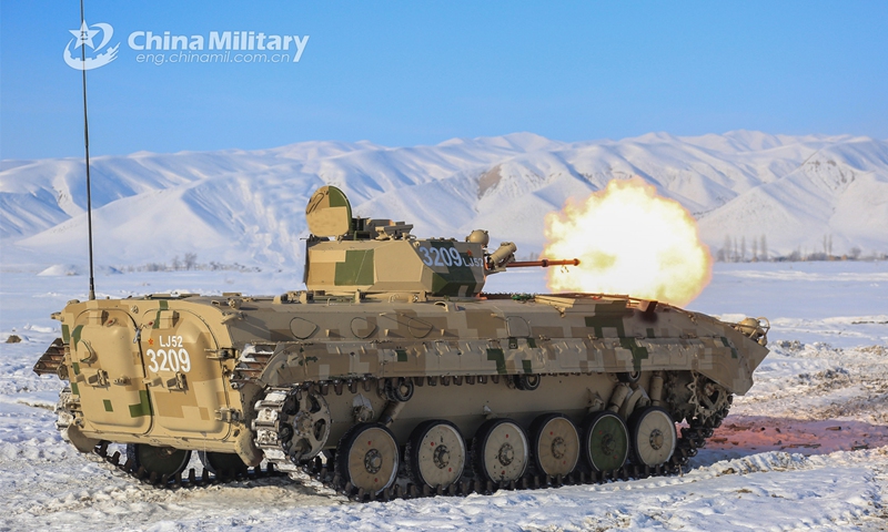 Soldiers assigned to an element under the PLA Xinjiang Military Command fire the main-gun of an armored vehicle at mock ground targets during a live-fire training exercise on January 3, 2023. (eng.chinamil.com.cn/Photo by He Rui)