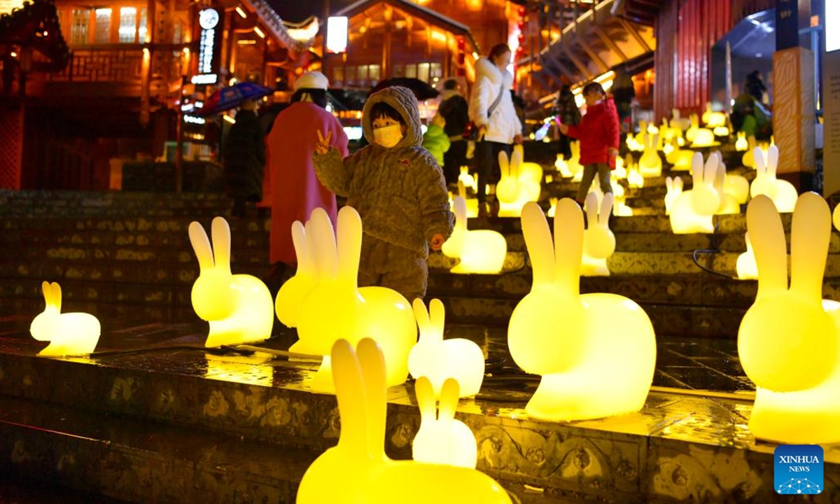 A child poses for a photo among rabbit-shaped lanterns at Xuan'en County, Enshi Tujia and Miao Autonomous Prefecture of central China's Hubei Province, Jan. 15, 2023. As the Chinese Lunar New Year of the Rabbit approaches, decorative items and handicraft works featuring the image of the rabbit, one of the 12 Chinese Zodiac animals, are sweeping the streets, adding festive atmosphere to the event. (Photo by Song Wen/Xinhua)