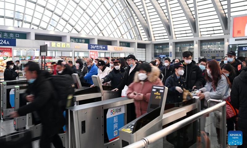 Passengers go through ticket gates at Tianjin West Railway Station in north China's Tianjin, Jan. 7, 2023. People's social and economic activities gradually return to normal after China's optimization of its COVID-19 response measures. (Xinhua/Li Ran)