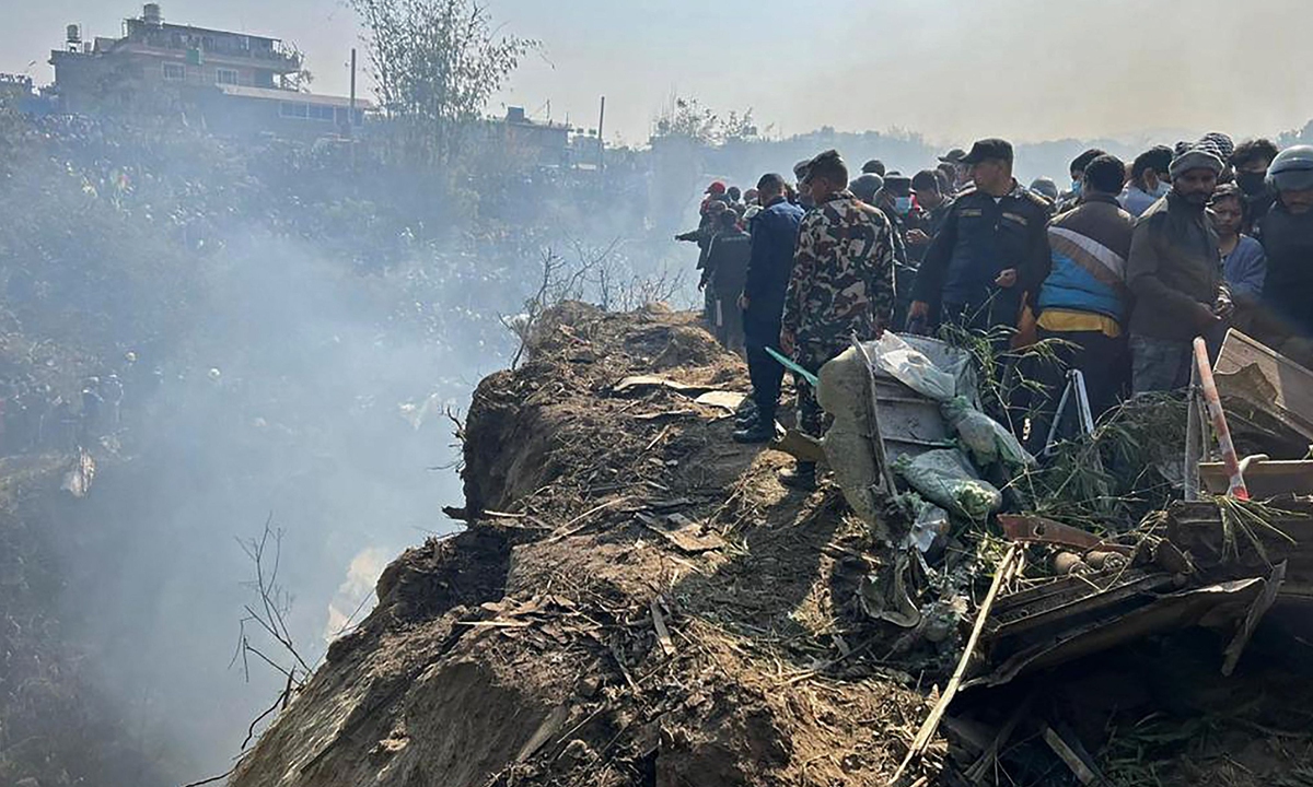 Rescuers and onlookers gather at the site of a plane crash in Pokhara on January 15, 2023. An aircraft with 72 people on board crashed in Nepal on January 15, Yeti Airlines and a local official said. Photo: VCG
