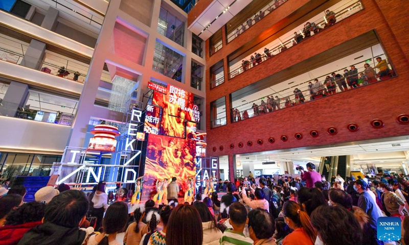 People watch a performance at a large commercial complex transformed from an old thermal power plant in north China's Tianjin, Jan. 1, 2023. People's social and economic activities gradually return to normal after China's optimization of its COVID-19 response measures. (Xinhua/Sun Fanyue)