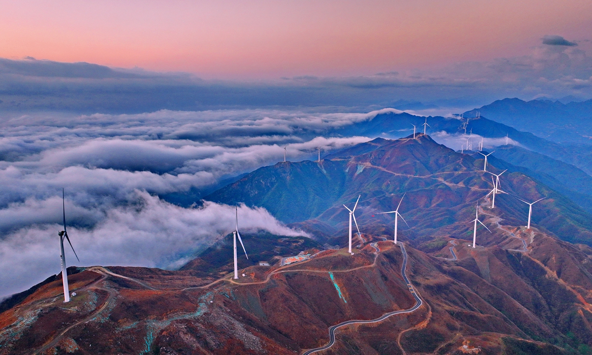 Dozens of wind turbines generate clean power in a wind power plant in Shangyou County, East China's Jiangxi Province, on January 14, 2023. Shangyou's Shuangxicao Mountain has become a scenic spot by building a wind power plant and tourism highways. Photo: IC