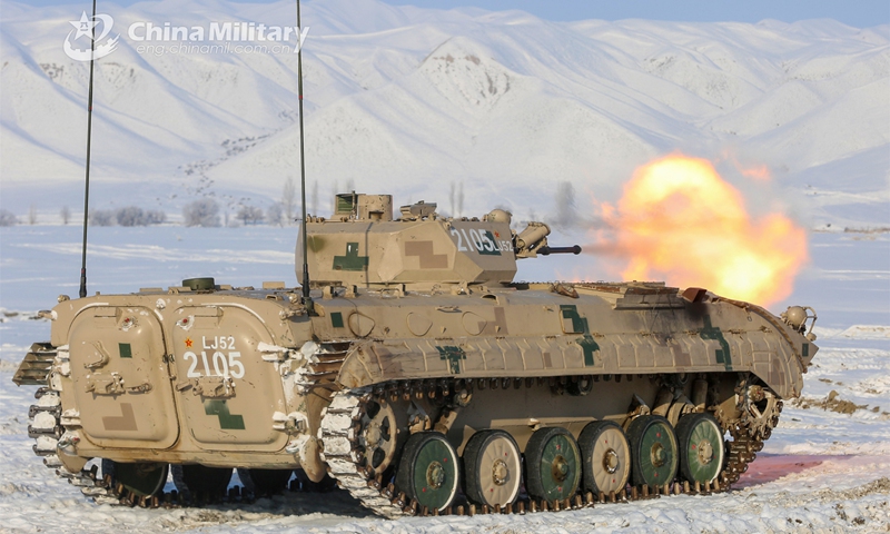 Soldiers assigned to an element under the PLA Xinjiang Military Command fire the main-gun of an armored vehicle at mock ground targets during a live-fire training exercise on January 3, 2023. (eng.chinamil.com.cn/Photo by He Rui)