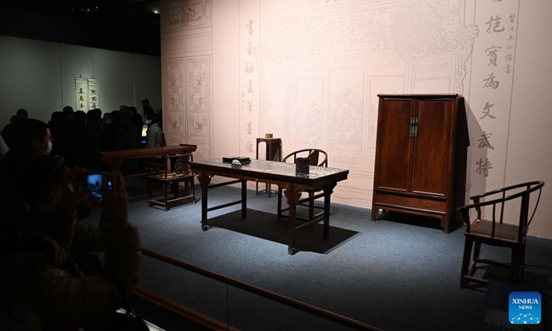 Visitors watch the replica of an ancient study at the Palace Museum in Beijing, capital of China, Jan. 16, 2023. A Joint Exhibition on Jinshi Culture and Arts Through the Ages, featuring Chinese ancient imperial scholars, kicked off at the Wumen Exhibition Hall of the Palace Museum. Some 179 selected artworks since the Tang Dynasty (618-907) were on display.(Photo: Xinhua)