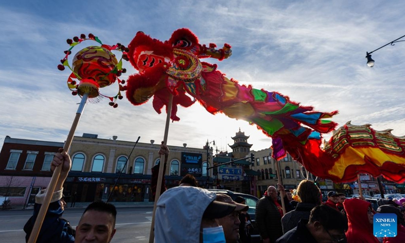 People perform the dragon dance during a ceremony for Chinese Lunar New Year celebration in Chinatown in Chicago, the United States, on Jan. 15, 2023. Chicago Chinatown has been decorated with hundreds of red lanterns to celebrate Chinese Lunar New Year.(Photo: Xinhua)