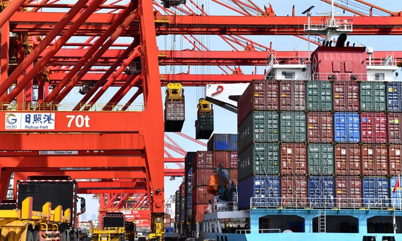 Trucks wait to load containers at a container terminal in Rizhao, east China's Shandong Province, March 28, 2022.(Photo: Xinhua)