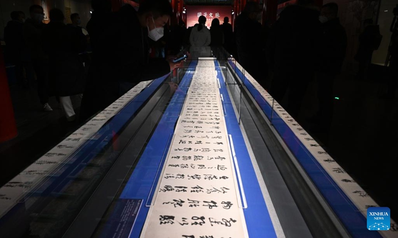 Visitors watch a piece of calligraphy work at the Palace Museum in Beijing, capital of China, Jan. 16, 2023. A Joint Exhibition on Jinshi Culture and Arts Through the Ages, featuring Chinese ancient imperial scholars, kicked off at the Wumen Exhibition Hall of the Palace Museum. Some 179 selected artworks since the Tang Dynasty (618-907) were on display.(Photo: Xinhua)