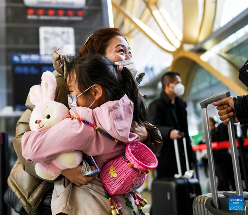 A woman hugs her daughter who came to pick her up at the Kunming Changshui International Airport in Kunming, southwest China's Yunnan Province, Jan. 15, 2023. China's Spring Festival travel rush kicked off on Jan. 7 this year and Chinese people are on their way to have a reunion with their loved ones.(Photo: Xinhua)