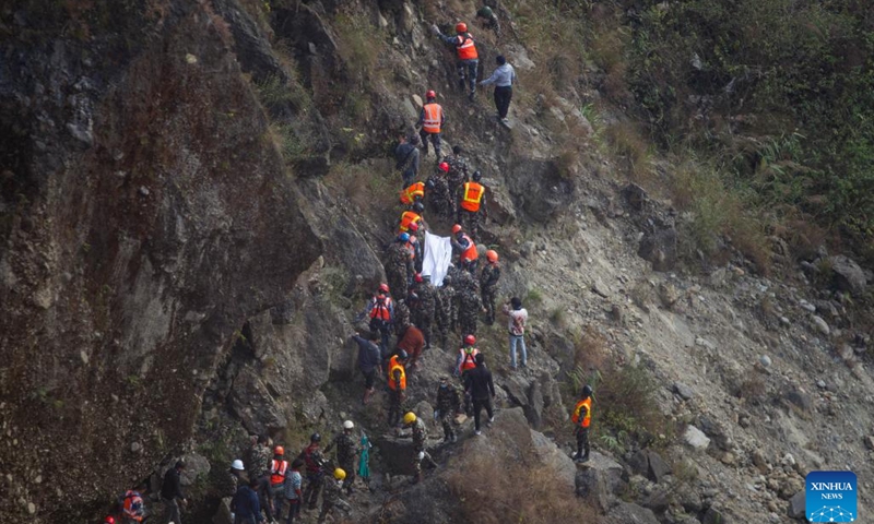 Rescuers carry a body at the crash site of a passenger plane near Pokhara, Nepal, on Jan. 17, 2023. With the second body recovered at the crash site of a Nepali passenger plane in central Nepal on Tuesday, 71 bodies had been found with the last missing victim remains to be confirmed, an official said.(Photo: Xinhua)