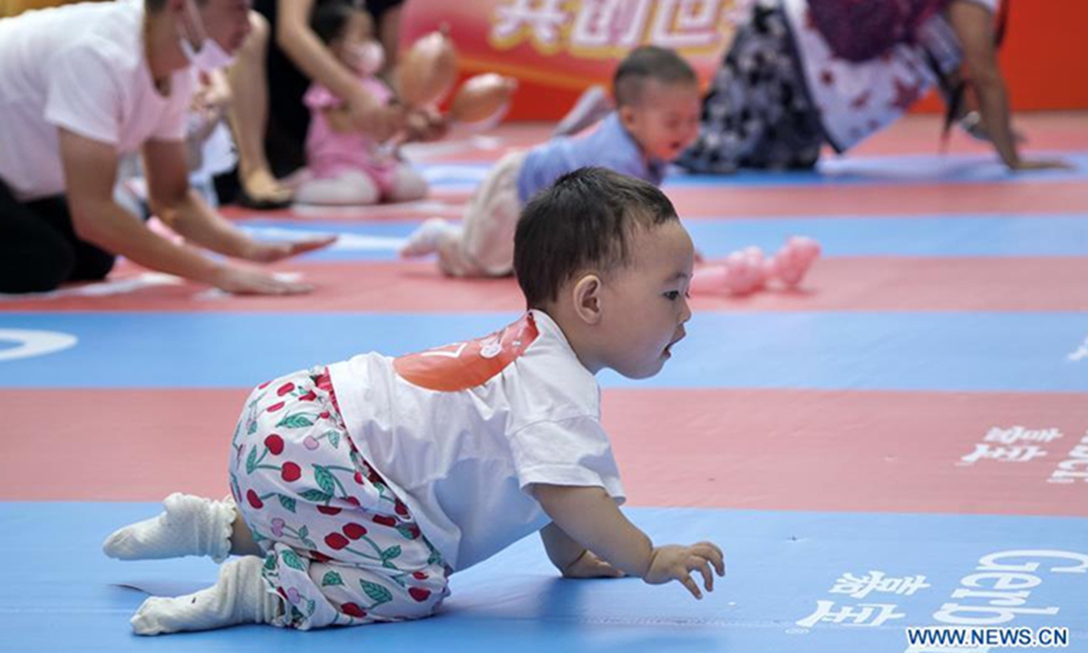 Babies participate in a baby crawling contest at a shopping center in Daxing District, Beijing, capital of China, Sept. 13, 2020. (Xinhua/Li Xin)