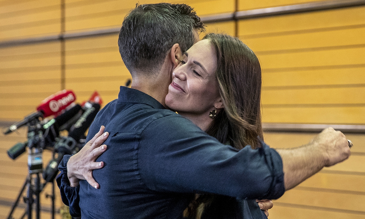 New Zealand Prime Minister Jacinda Ardern hugs her fiancé Clark Gayford after announcing her resignation at a press conference in Napier, New Zealand, on January 19, 2023. Photo: VCG
