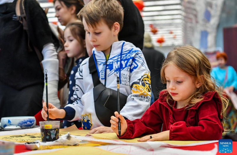 Children practice calligraphy during a Chinese culture experience activity celebrating the Chinese New Year in Moscow, Russia, Jan. 21, 2023. (Xinhua/Cao Yang)
