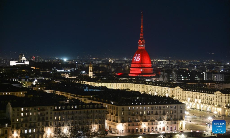 A Chinese character Fu, which means good fortune, and red light are projected on the Mole Antonelliana to celebrate the Chinese New Year in Turin, Italy, on Jan. 21, 2023. (Photo by Federico Tardito/Xinhua)