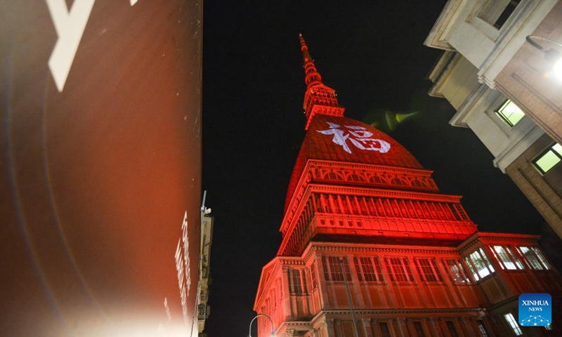 A Chinese character Fu, which means good fortune, and red light are projected on the Mole Antonelliana to celebrate the Chinese New Year in Turin, Italy, on Jan. 21, 2023. (Photo by Federico Tardito/Xinhua)