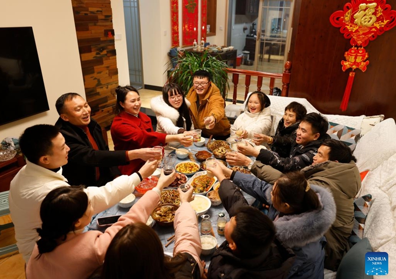 People enjoy a family feast on the eve of the Spring Festival in Zunyi, southwest China's Guizhou Province, Jan. 21, 2023. On the eve of the Spring Festival in China, while some people reunite with their families and friends, there are others who still stick to their posts away from home. Nevertheless, nothing can stop a warm gathering and delicious festive dinner while they await the arrival of the Spring Festival. (Photo by Zhao Yongzhang/Xinhua)