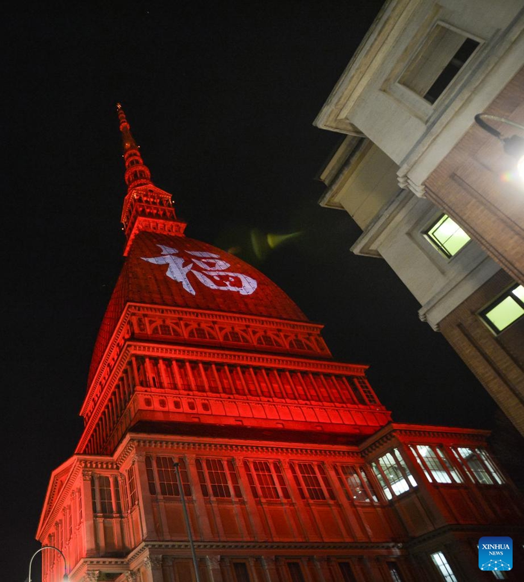 A Chinese character Fu, which means good fortune, and red light are projected on the Mole Antonelliana to celebrate the Chinese New Year in Turin, Italy, on Jan. 21, 2023. (Photo by Federico Tardito/Xinhua)