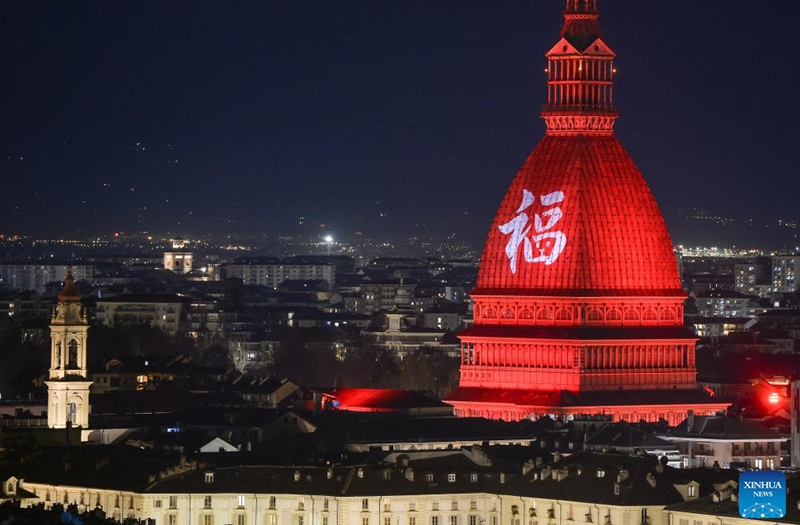 A Chinese character Fu, which means good fortune, and red light are projected on the Mole Antonelliana to celebrate the Chinese New Year in Turin, Italy, on Jan. 21, 2023. (Photo by Federico Tardito/Xinhua)