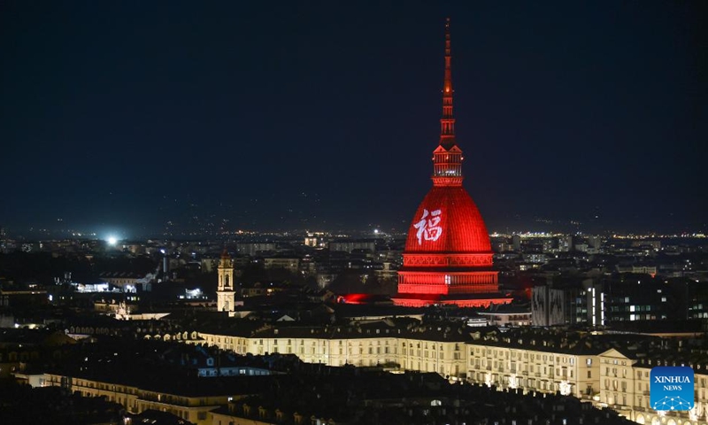 A Chinese character Fu, which means good fortune, and red light are projected on the Mole Antonelliana to celebrate the Chinese New Year in Turin, Italy, on Jan. 21, 2023. (Photo by Federico Tardito/Xinhua)