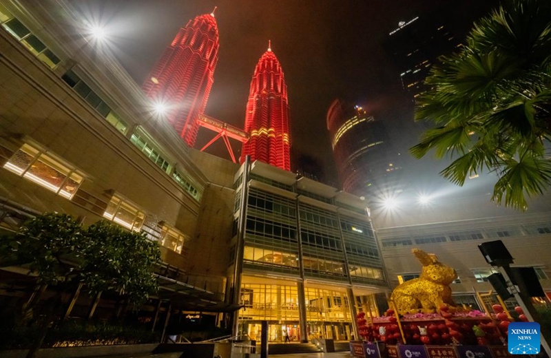 The Petronas Twin Towers are illuminated in red in celebration of the Chinese New Year in Kuala Lumpur, Malaysia, Jan. 22, 2023. (Xinhua/Zhu Wei)
