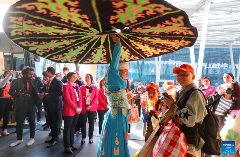An Egyptian artist performs a traditional Egyptian folk dance to welcome Chinese tourists at the Cairo International Airport in Cairo, Egypt, Jan. 20, 2023. Ahead of the upcoming Chinese New Year, Egypt received the first Chinese tourist group on Friday since the outbreak of COVID-19 three years ago. (Xinhua/Sui Xiankai)