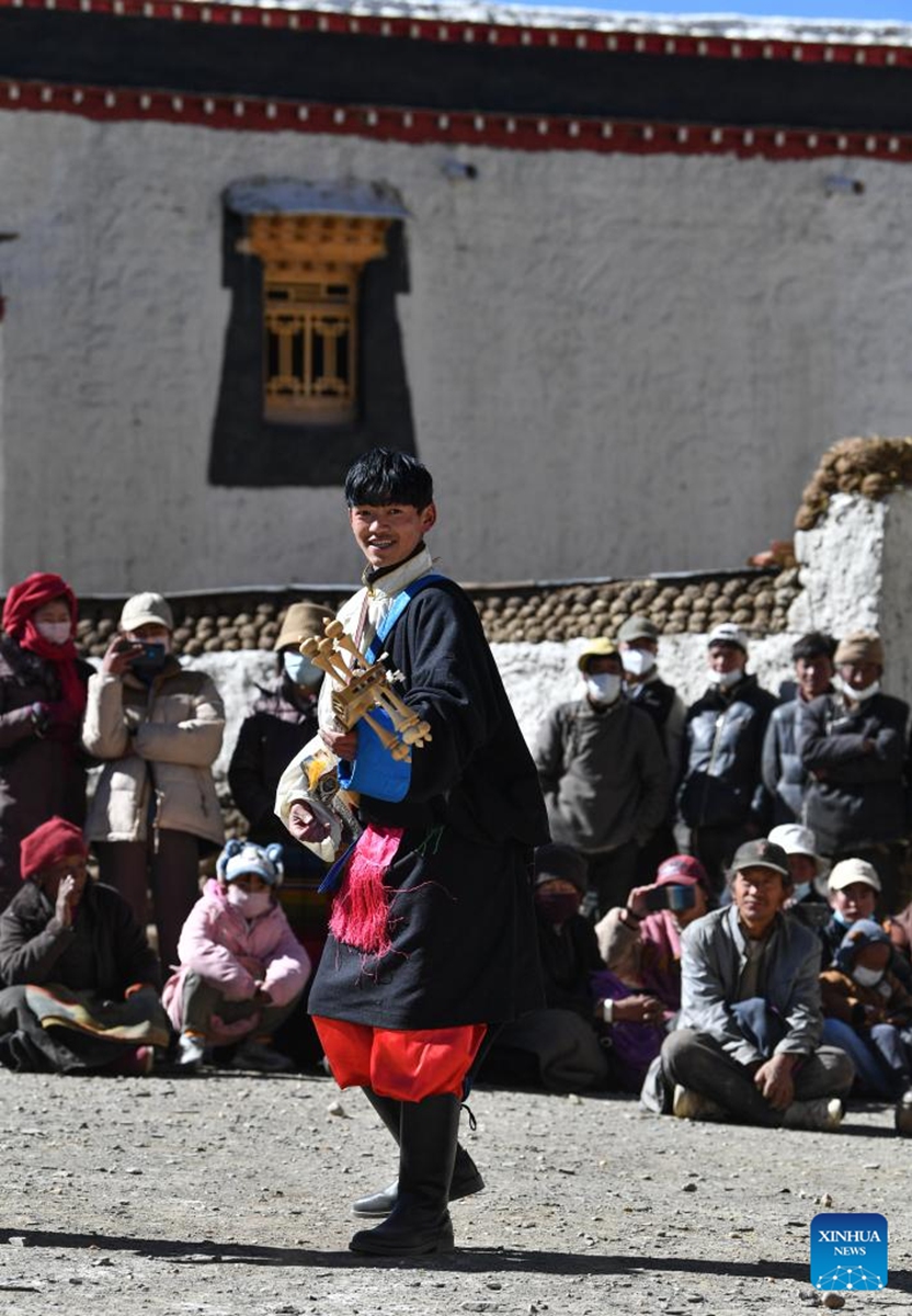 An actor plays musical instrument during a village gala performance to celebrate Sonam Losar and the Spring Festival in Pucun Village, Mangpu Township of Xigaze, southwest China's Tibet Autonomous Region, Jan. 21, 2023. (Xinhua/Jigme Dorje)