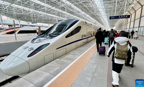 Passengers take a train at Beijing North Railway Station in Beijing, capital of China, Jan. 24, 2023. The Beijing-Zhangjiakou high-speed railway line brings great convenience to people's skiing trip to Chongli district of Zhangjiakou City in north China's Hebei province. (Xinhua/Li Xin)