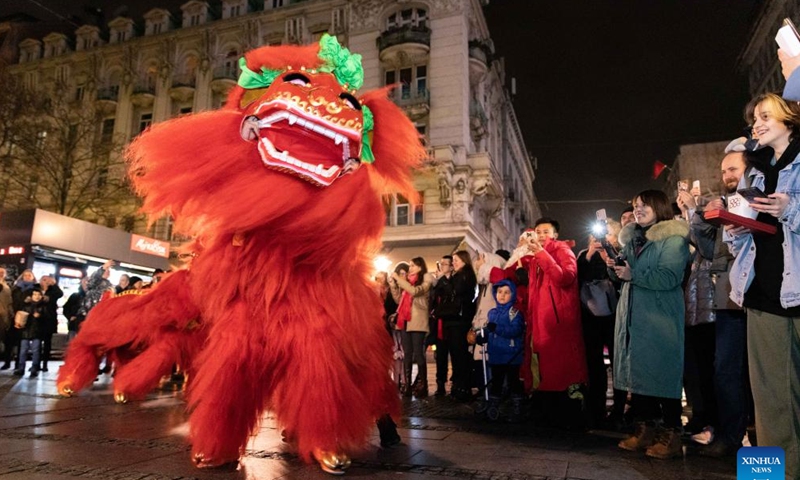 People watch a lion dance performance celebrating the Chinese Lunar New Year in Belgrade, Serbia, Jan. 21, 2023. (Photo by Wang Wei/Xinhua)
