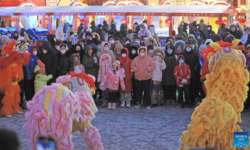 People watch a lion dance performance at Huangsi Temple Fair during the Spring Festival holiday in Shenyang, capital of northeast China's Liaoning Province, Jan. 23, 2023. Various activities were held here at the 6-day fair, starting from Jan. 22, to celebrate the Spring Festival. (Xinhua/Yang Qing)