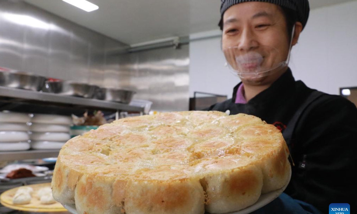 A chef displays local steamed stuffed buns at a restaurant in Gaomi, east China's Shandong Province, Jan. 24, 2023. People enjoy various kinds of cuisine in China during the Spring Festival holiday. (Photo by Li Haitao/Xinhua)


