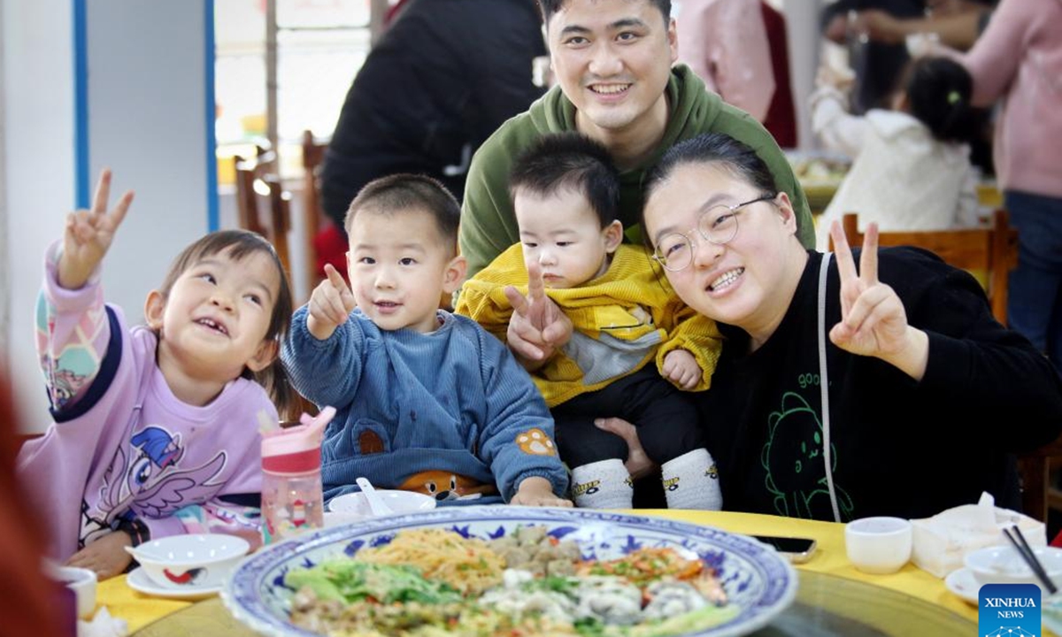 A family enjoys a meal in Heshan, south China's Guangdong Province, Jan. 23, 2023. People enjoy various kinds of cuisine in China during the Spring Festival holiday. (Photo by Huang Jiming/Xinhua)




