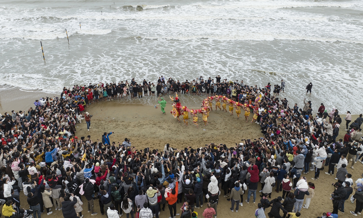 People enjoy a lion dance performance in celebration of the Chinese New Year on January 27, 2023 in Zhanjiang, South China's Guangdong Province. Photo: VCG