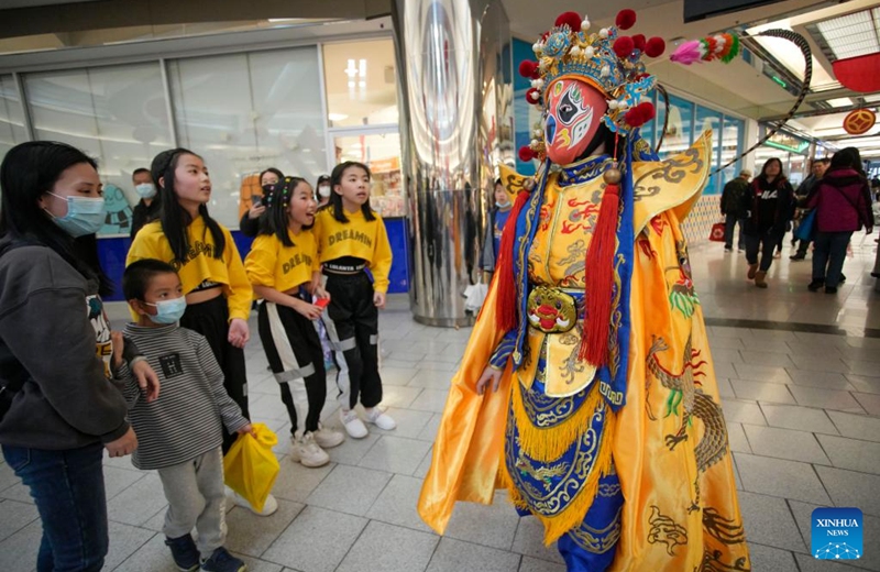 An artist performs traditional Bian Lian, or face-changing performance, during the Chinese New Year celebration event at Lansdowne Centre in Richmond, British Columbia, Canada, Jan. 28, 2023. The event features a wide variety of cultural activities that allow the audience to experience the traditional culture of the Chinese New Year. (Photo by Liang Sen/Xinhua)