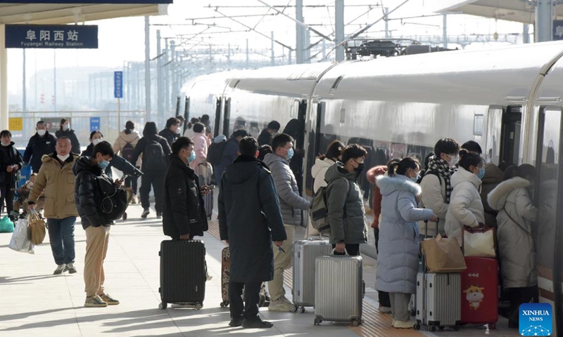 Passengers line up to board a train at Fuyang West Railway Station in Fuyang City, east China's Anhui Province, Jan. 27, 2023. Fuyang West Railway Station was bustling with passengers on Friday, the last day of the Spring Festival holiday. As more railway stations have been put into use in the city, more people choose to travel by high-speed train to go to work or visit families. (Photo: Xinhua)