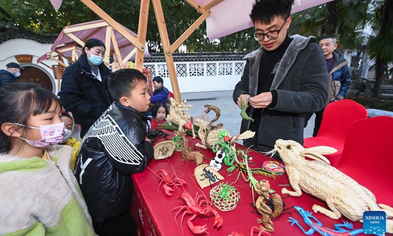 A craftsman shows weaving handicraft at Aoshan Lantern Festival in Xincheng ancient town of Xiuzhou District in Jiaxing, east China's Zhejiang Province, Jan. 29, 2023. The Aoshan Lantern Festival, which has a history of hundreds of years, kicked off here on Sunday.(Photo: Xinhua)