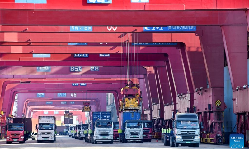 Trucks transport containers at Qianwan Container Terminal of Qingdao Port in east China's Shandong Province, Jan. 27, 2023.(Photo: Xinhua)