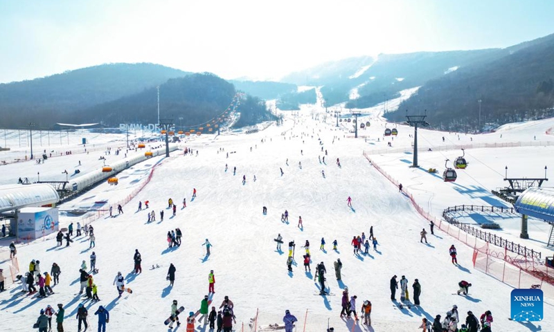 This aerial photo taken on Jan. 30, 2023 shows tourists skiing at the Lake Songhua Resort in Jilin City, northeast China's Jilin Province.Driven by the 2022 Beijing Winter Olympics, ice-and-snow tourism has gradually gained popularity among Chinese people, and northeast China is among the top destinations due to its cold winter.(Photo: Xinhua)
