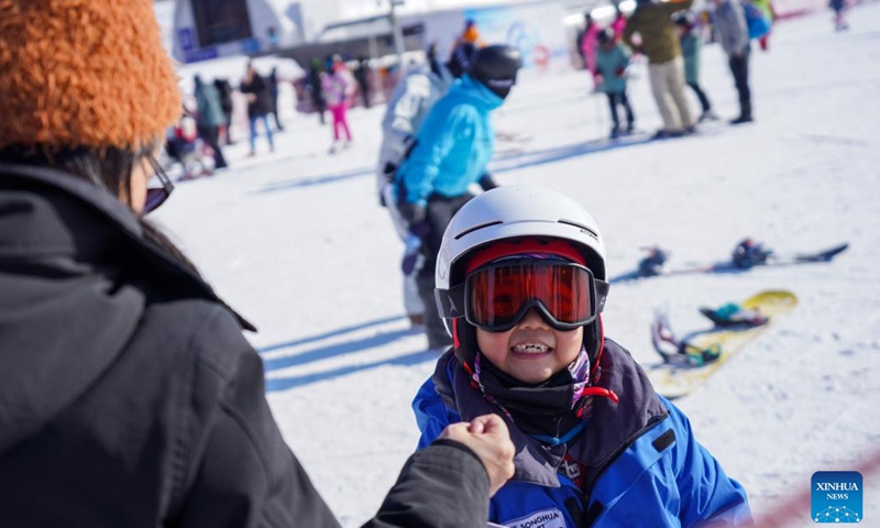 A child plays at the Lake Songhua Resort in Jilin City, northeast China's Jilin Province, Jan. 30, 2023.Driven by the 2022 Beijing Winter Olympics, ice-and-snow tourism has gradually gained popularity among Chinese people, and northeast China is among the top destinations due to its cold winter.(Photo: Xinhua)