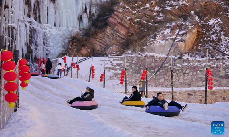 Tourists have fun at Tianheshan scenic spot of Xingtai City, north China's Hebei Province, Jan. 27, 2023. Xingtai has developed ice and snow tourism to boost local economy in recent years.(Photo: Xinhua)