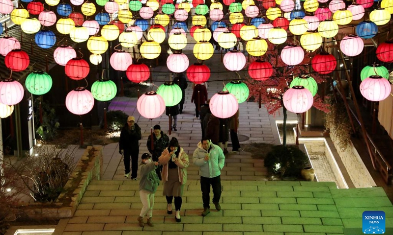 People enjoy light installations in celebration of the upcoming Latern Festival at a scenic spot in the western coast economic zone in Qingdao, east China's Shandong Province, Jan. 30, 2023. The Lantern Festival, the 15th day of the first month of the Chinese lunar calendar, falls on Feb. 5 this year. The festival features family reunions, feasts, light shows and various cultural activities.(Photo: Xinhua)