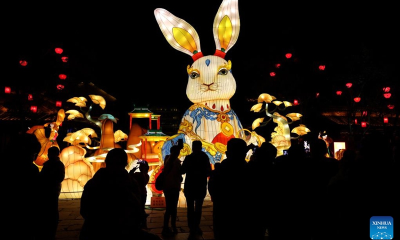 People watch a gigantic rabbit-shaped lantern in celebration of the upcoming Latern Festival at Taierzhuang ancient city of Zaozhuang, east China's Shandong Province, Jan. 30, 2023. The Lantern Festival, the 15th day of the first month of the Chinese lunar calendar, falls on Feb. 5 this year. The festival features family reunions, feasts, light shows and various cultural activities.(Photo: Xinhua)